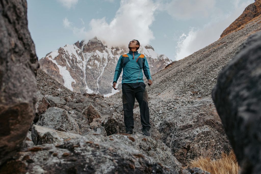 Person hiking in the Andes with breathtaking mountain views near Nevado Ausangate, Cusco, Peru.