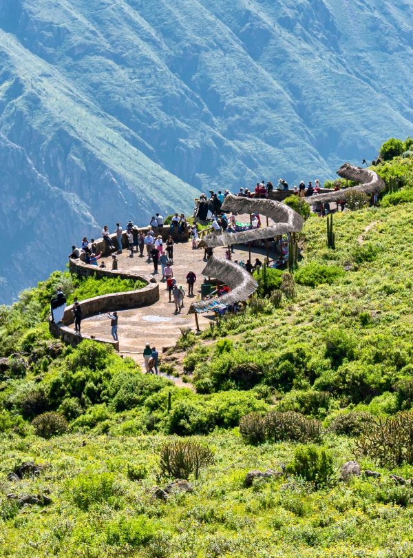 Tourists enjoy a breathtaking view from a scenic overlook at Colca Canyon in Arequipa, Peru.